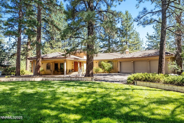 390 Sylvan Ct, Verdi, NV 89439 - mediterranean / spanish-style home with a tiled roof, a garage, a front lawn, and driveway