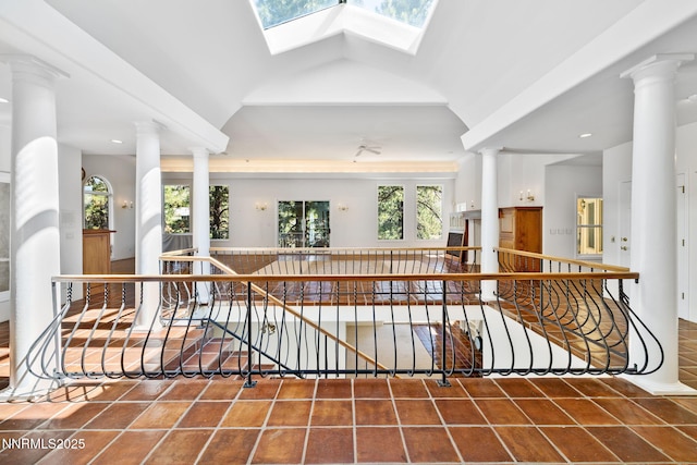 390 Sylvan Ct, Verdi, NV 89439 - corridor with tile patterned floors, an upstairs landing, vaulted ceiling, and a skylight