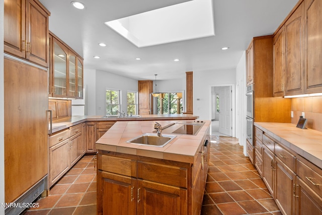 390 Sylvan Ct, Verdi, NV 89439 - kitchen featuring recessed lighting, a sink, a skylight, double oven, and tasteful backsplash