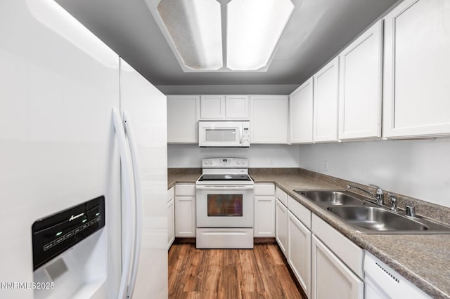 2400 Tripp Dr Unit 7, Reno, NV 89512 - kitchen featuring white appliances, a sink, wood finished floors, and white cabinetry