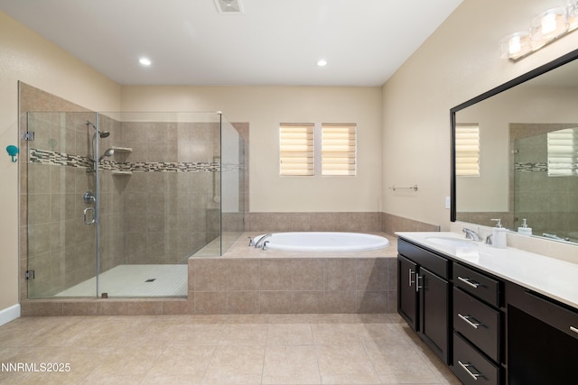 9845 Sea Breeze Ln, Reno, NV 89521 - full bathroom featuring a garden tub, vanity, tile patterned floors, a stall shower, and recessed lighting
