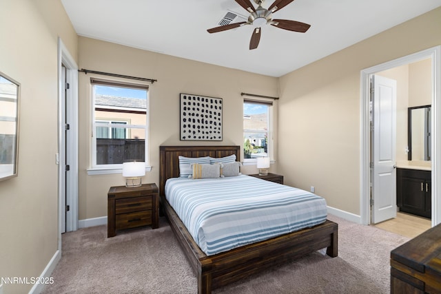 9845 Sea Breeze Ln, Reno, NV 89521 - bedroom featuring light colored carpet, baseboards, ensuite bathroom, and ceiling fan