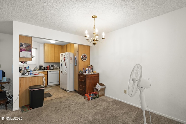 2627 Sunny Slope Dr, Sparks, NV 89434 - kitchen featuring white appliances, a chandelier, light colored carpet, light countertops, and a textured ceiling