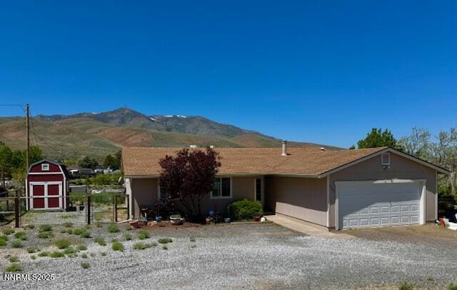 2265 Dakota Way, Reno, NV 89506 - single story home featuring an attached garage, a mountain view, gravel driveway, and a storage unit