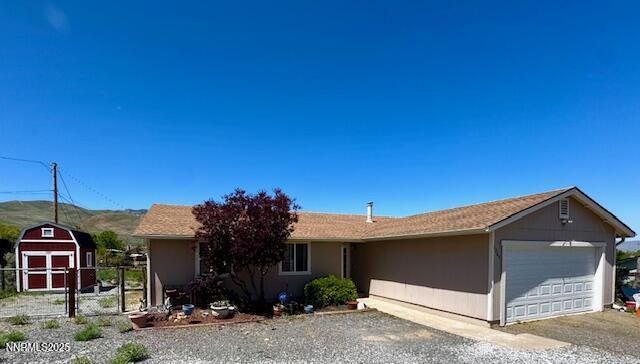 2265 Dakota Way, Reno, NV 89506 - single story home with an attached garage, a shed, and gravel driveway