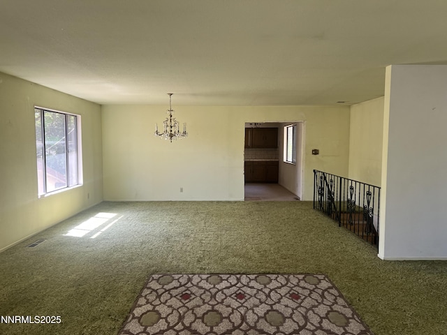 124 Mark Twain Ave, Reno, NV 89509 - unfurnished room with carpet floors, a chandelier, and healthy amount of natural light
