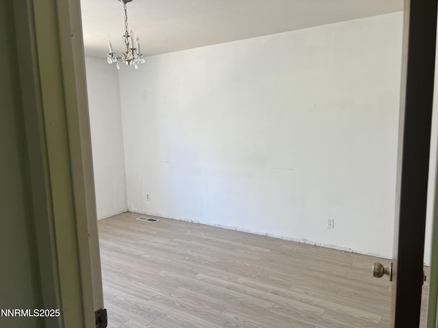 124 Mark Twain Ave, Reno, NV 89509 - spare room featuring a chandelier and light wood-type flooring