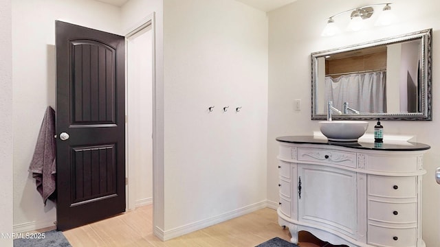 5895 Brooke Dr, Winnemucca, NV 89445 - full bath with wood finished floors, vanity, and baseboards