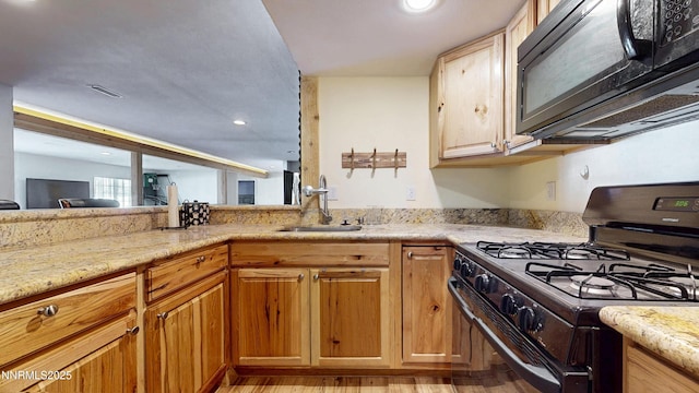 5895 Brooke Dr, Winnemucca, NV 89445 - kitchen featuring black appliances, a sink, light stone countertops, light wood-style flooring, and recessed lighting