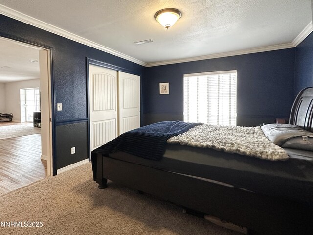 5895 Brooke Dr, Winnemucca, NV 89445 - carpeted bedroom with a closet, ornamental molding, baseboards, and a textured ceiling