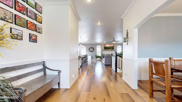 5895 Brooke Dr, Winnemucca, NV 89445 - hall with light wood finished floors, arched walkways, ornamental molding, recessed lighting, and baseboards