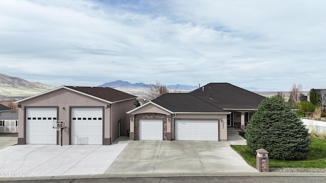 5895 Brooke Dr, Winnemucca, NV 89445 - ranch-style house with a mountain view, a garage, and driveway