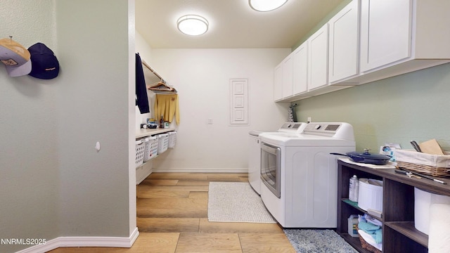 5895 Brooke Dr, Winnemucca, NV 89445 - laundry area featuring washer and dryer, cabinet space, light wood-style floors, and baseboards