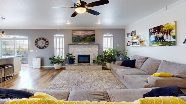 5895 Brooke Dr, Winnemucca, NV 89445 - living area with light wood-style floors, ornamental molding, a ceiling fan, baseboards, and a fireplace