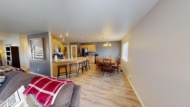 165 W National Ave, Winnemucca, NV 89445 - living room featuring baseboards, a chandelier, light wood-type flooring, and recessed lighting