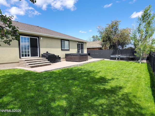 165 W National Ave, Winnemucca, NV 89445 - rear view of house featuring a hot tub, entry steps, stucco siding, a patio area, and central AC