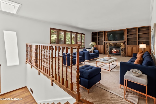 5 Ute Ct, Zephyr Cove, NV 89448 - living room featuring baseboards, a stone fireplace, built in features, and wood finished floors