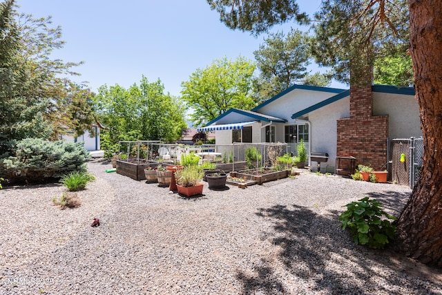 1745 Fir Tree Cir, Minden, NV 89423 - back of house featuring a garden and stucco siding