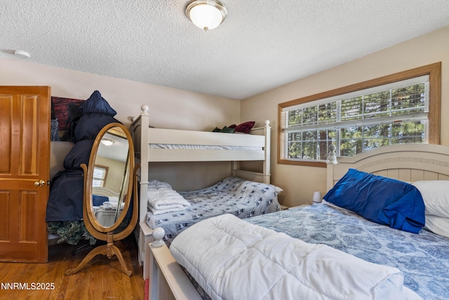 2450 Pinter Ave, South Lake Tahoe, CA 96150 - bedroom with wood finished floors and a textured ceiling