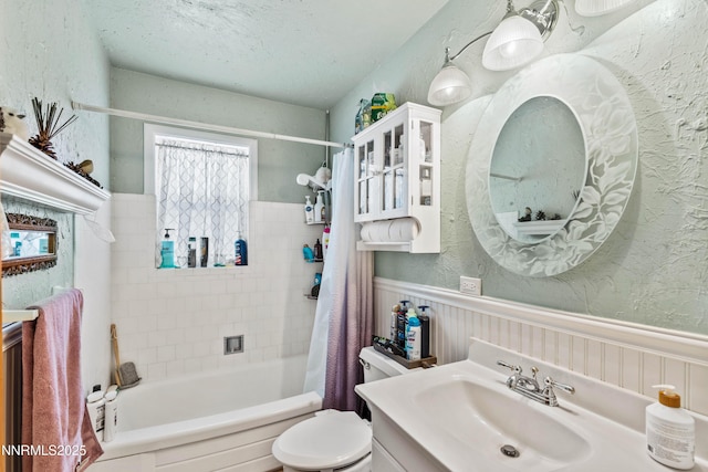 2450 Pinter Ave, South Lake Tahoe, CA 96150 - full bathroom featuring a wainscoted wall, vanity, shower / tub combo with curtain, toilet, and a textured wall