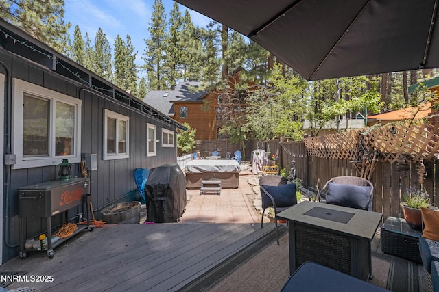 2450 Pinter Ave, South Lake Tahoe, CA 96150 - wooden deck featuring a hot tub, a fenced backyard, and a patio