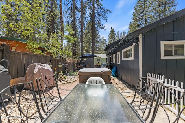 2450 Pinter Ave, South Lake Tahoe, CA 96150 - view of patio / terrace featuring a hot tub and outdoor dining area