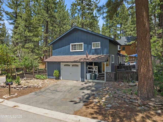 2450 Pinter Ave, South Lake Tahoe, CA 96150 - rustic home with a porch, asphalt driveway, roof with shingles, and an attached garage