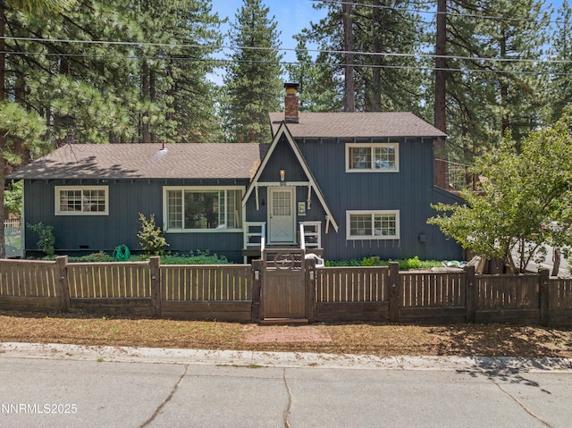 2450 Pinter Ave, South Lake Tahoe, CA 96150 - a-frame style home featuring a chimney, a fenced front yard, a shingled roof, and a gate