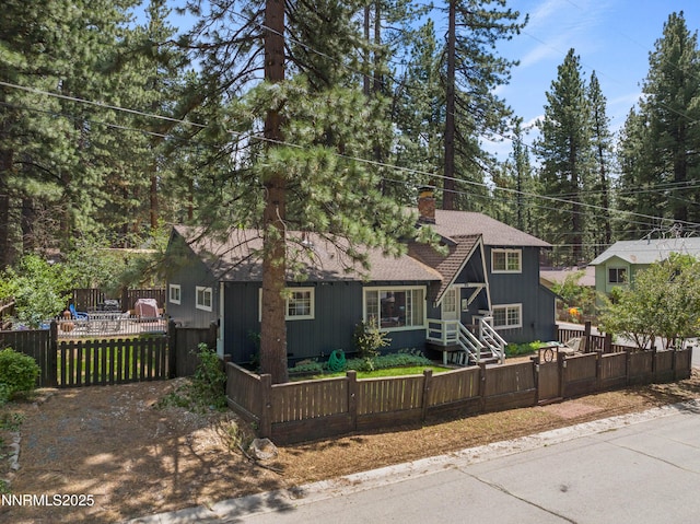 2450 Pinter Ave, South Lake Tahoe, CA 96150 - view of front facade with a gate, a fenced front yard, a chimney, and a shingled roof