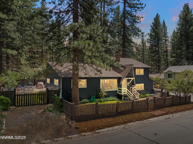2450 Pinter Ave, South Lake Tahoe, CA 96150 - view of front facade featuring a gate, a chimney, a fenced front yard, and board and batten siding