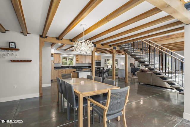 736 Kelly Dr, Incline Village, NV 89451 - dining area with a chandelier, stairway, baseboards, beamed ceiling, and finished concrete floors