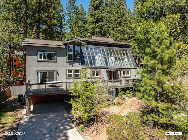 736 Kelly Dr, Incline Village, NV 89451 - view of front of property featuring a deck, stucco siding, and concrete driveway