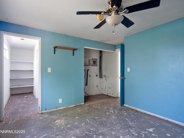 639 Mustang Ln, Gardnerville, NV 89410 - unfurnished bedroom with unfinished concrete flooring, baseboards, a ceiling fan, and electric panel