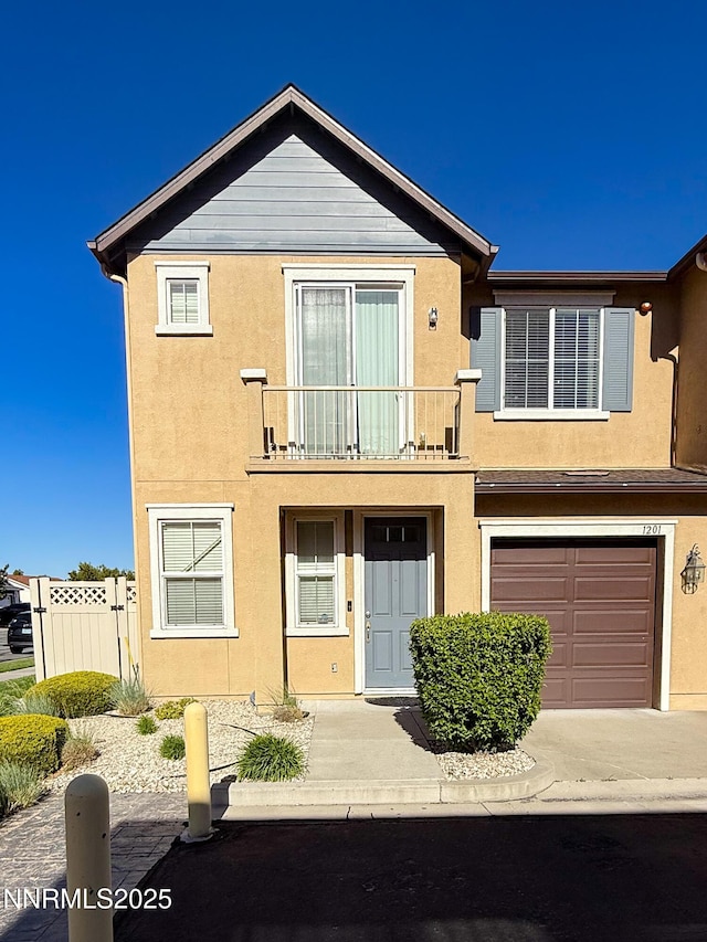 1201 Fonterra Way, Carson City, NV 89701 - townhome / multi-family property featuring a balcony, stucco siding, an attached garage, and concrete driveway