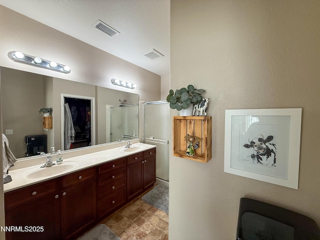 1201 Fonterra Way, Carson City, NV 89701 - full bathroom featuring a shower stall, double vanity, and stone finish floors
