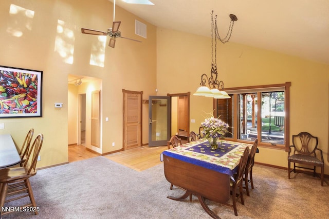 1724 Mohican Dr, South Lake Tahoe, CA 96150 - dining area featuring carpet, high vaulted ceiling, a ceiling fan, and a skylight