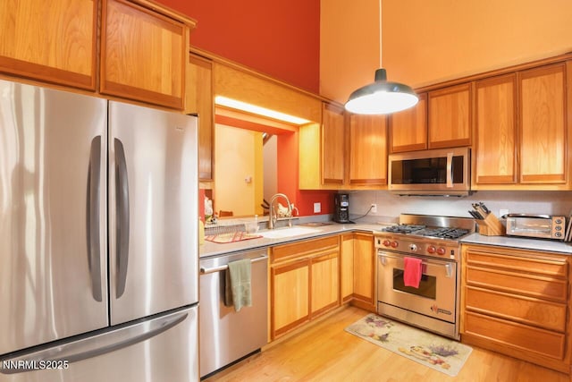 1724 Mohican Dr, South Lake Tahoe, CA 96150 - kitchen featuring stainless steel appliances, light countertops, light wood finished floors, and pendant lighting