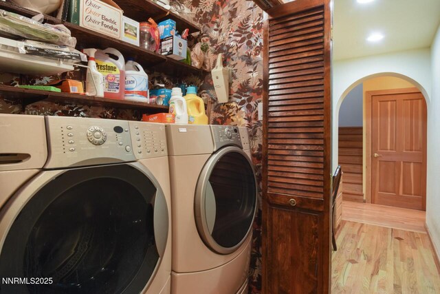1724 Mohican Dr, South Lake Tahoe, CA 96150 - laundry room with washer and clothes dryer, light wood-style floors, and arched walkways