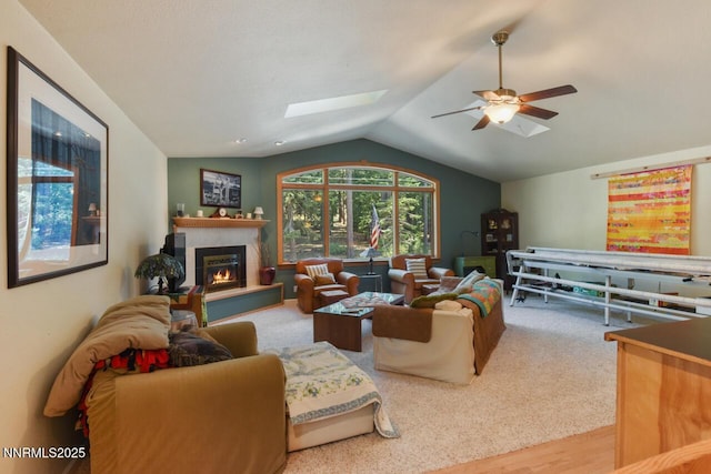 1724 Mohican Dr, South Lake Tahoe, CA 96150 - living room featuring a skylight, vaulted ceiling, ceiling fan, a glass covered fireplace, and wood finished floors