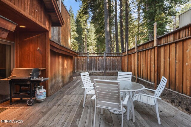 1724 Mohican Dr, South Lake Tahoe, CA 96150 - wooden terrace featuring a fenced backyard, outdoor dining area, and area for grilling
