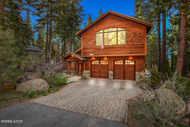 1724 Mohican Dr, South Lake Tahoe, CA 96150 - chalet / cabin with an attached garage, decorative driveway, and stone siding