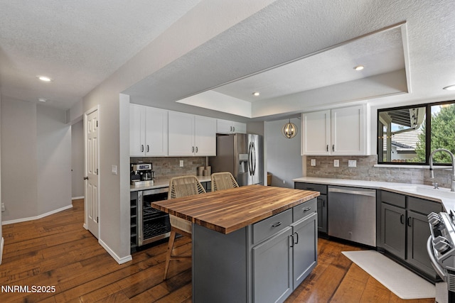1626 Spring View Ct, Sparks, NV 89436 - kitchen featuring stainless steel appliances, butcher block countertops, wine cooler, white cabinetry, and recessed lighting