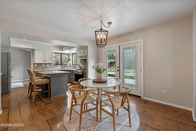1626 Spring View Ct, Sparks, NV 89436 - dining area featuring a chandelier, dark wood-type flooring, and baseboards