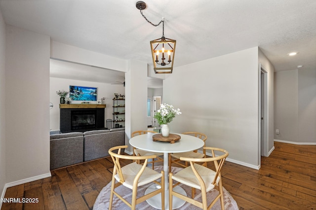1626 Spring View Ct, Sparks, NV 89436 - dining space featuring wood-type flooring, baseboards, a brick fireplace, a chandelier, and recessed lighting
