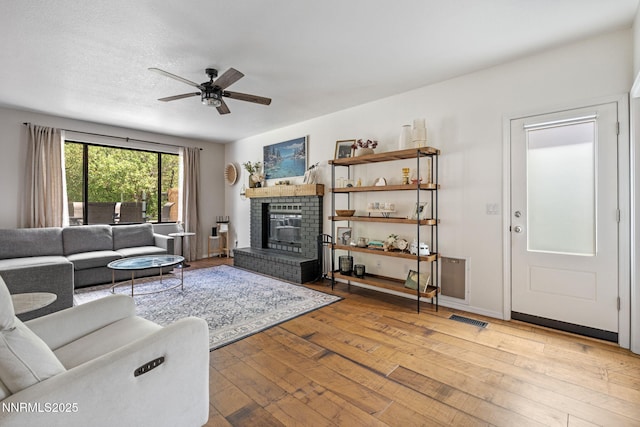 1626 Spring View Ct, Sparks, NV 89436 - living area with hardwood / wood-style floors, a brick fireplace, and ceiling fan