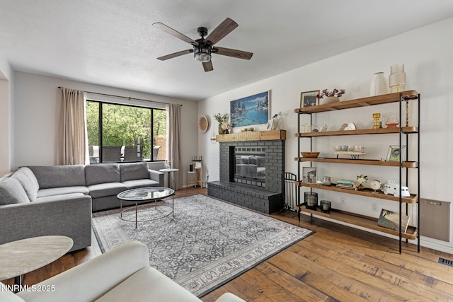 1626 Spring View Ct, Sparks, NV 89436 - living area with wood-type flooring, a ceiling fan, and a fireplace