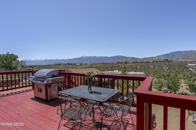 4840 Gentry Ln, Carson City, NV 89701 - wooden deck featuring a grill, a mountain view, and outdoor dining area