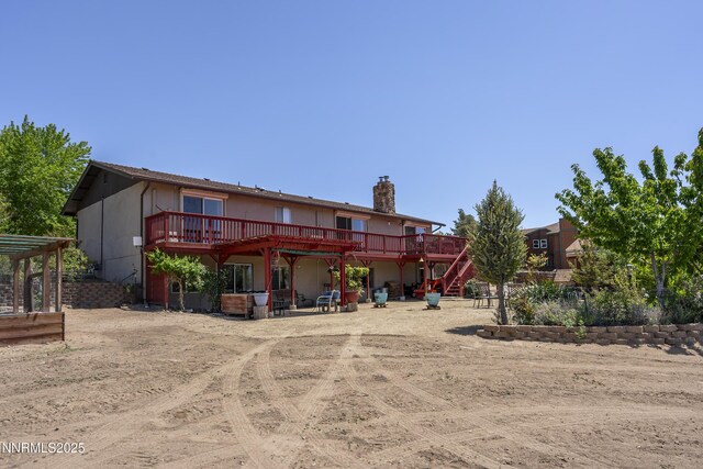 4840 Gentry Ln, Carson City, NV 89701 - back of property with a deck, a chimney, and stairway