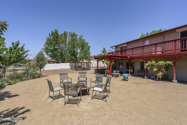 4840 Gentry Ln, Carson City, NV 89701 - view of patio featuring a fire pit and a wooden deck