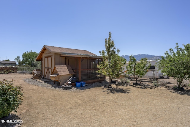 4840 Gentry Ln, Carson City, NV 89701 - rear view of house with an outbuilding, exterior structure, and a mountain view